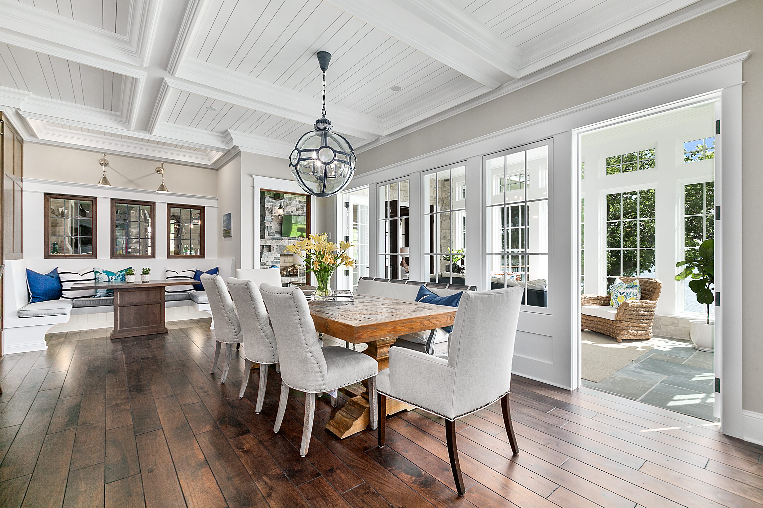 Informal bench dining and spacious area next to bright and cheery sunroom