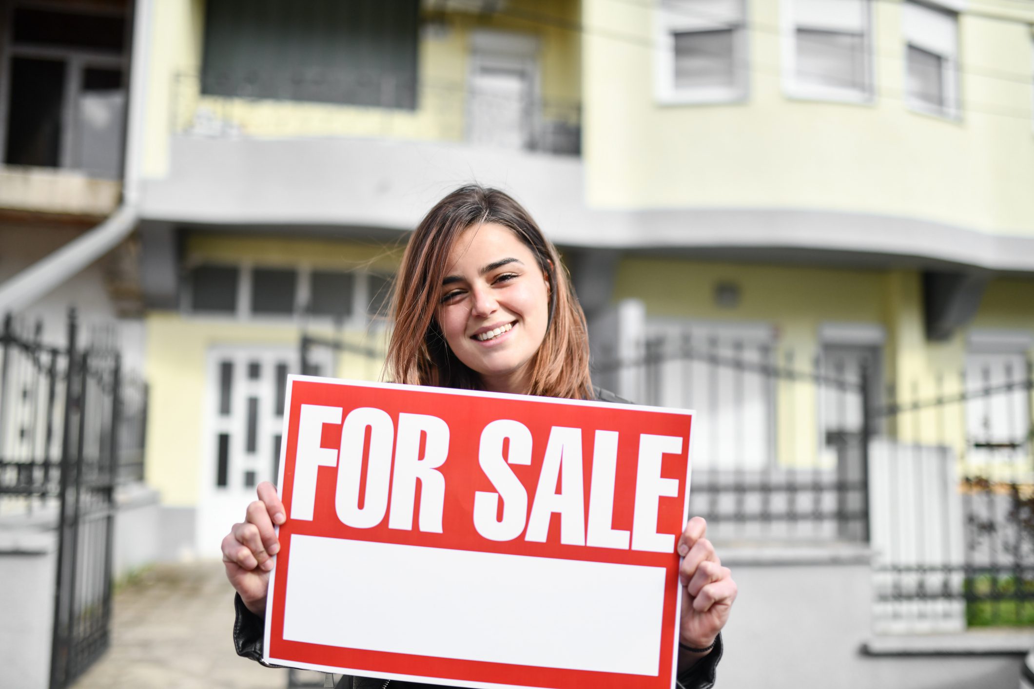 Smiling Female Beauty Putting Her House Up For Sale